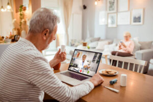 Close up of a senior man using remote patient monitoring solutions in the form of an RPM device